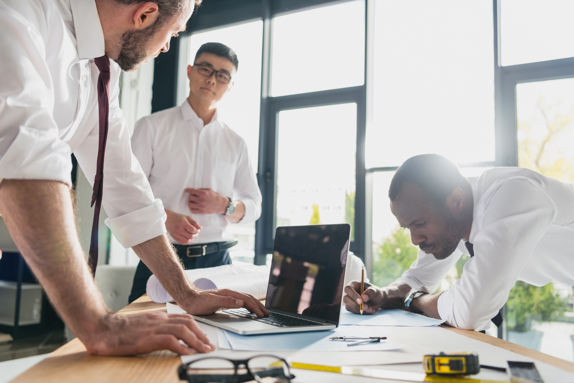 professional architects in formal wear working at modern office, businessmen group